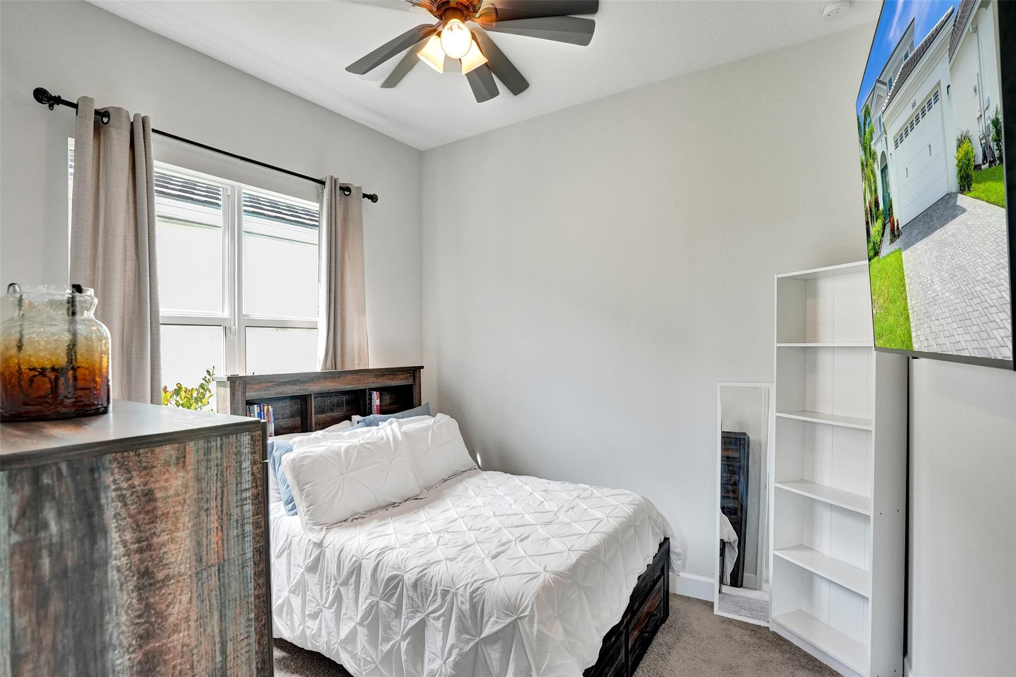 5416 Macoon Way Loxahatchee, FL 33470 - Photo 19 of 43 a bedroom with a bed and a window