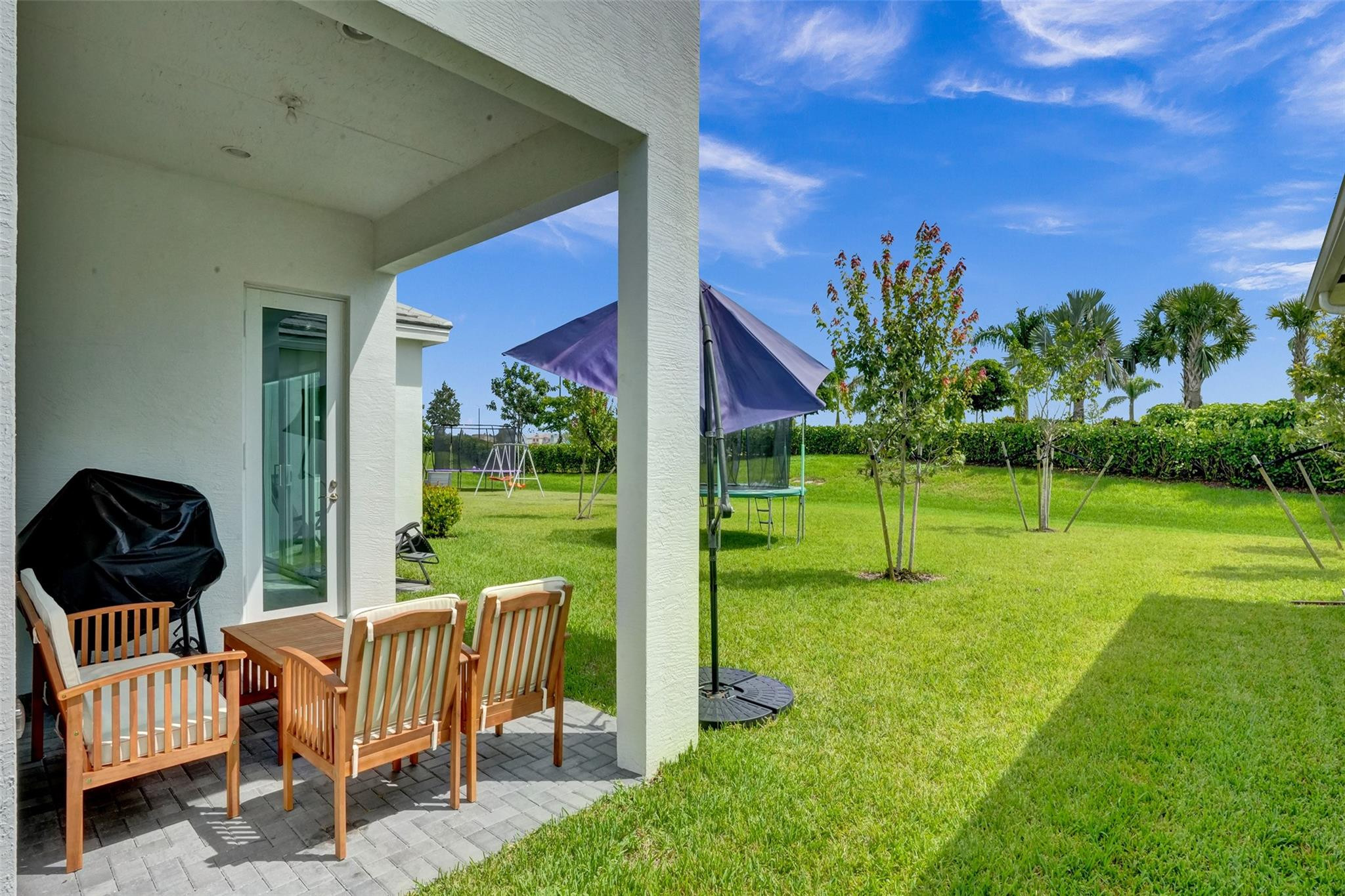 5416 Macoon Way Loxahatchee, FL 33470 - Photo 23 of 43 a view of a chair and table in backyard of the house