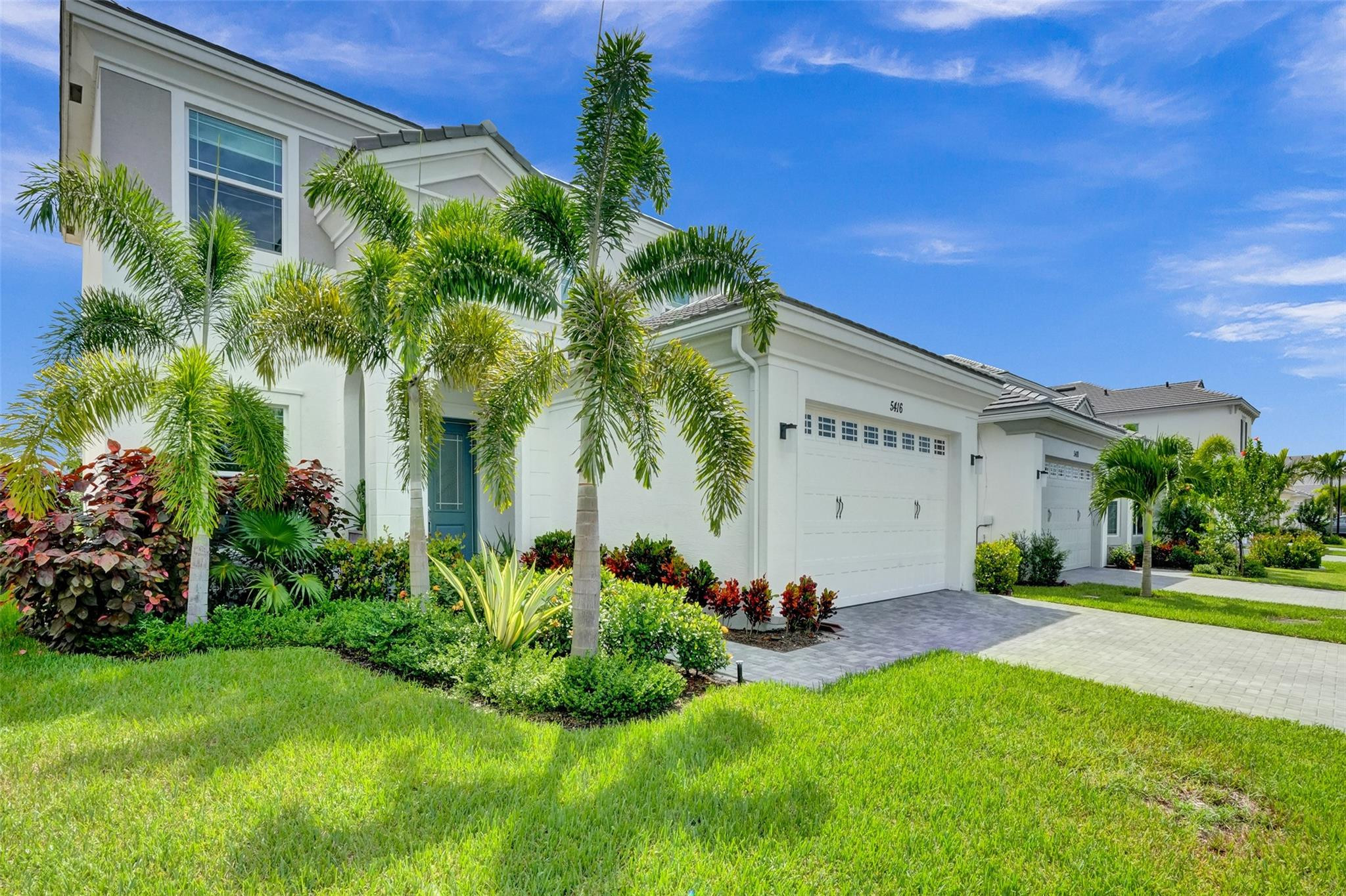 5416 Macoon Way Loxahatchee, FL 33470 - Photo 24 of 43 a front view of a house with garden