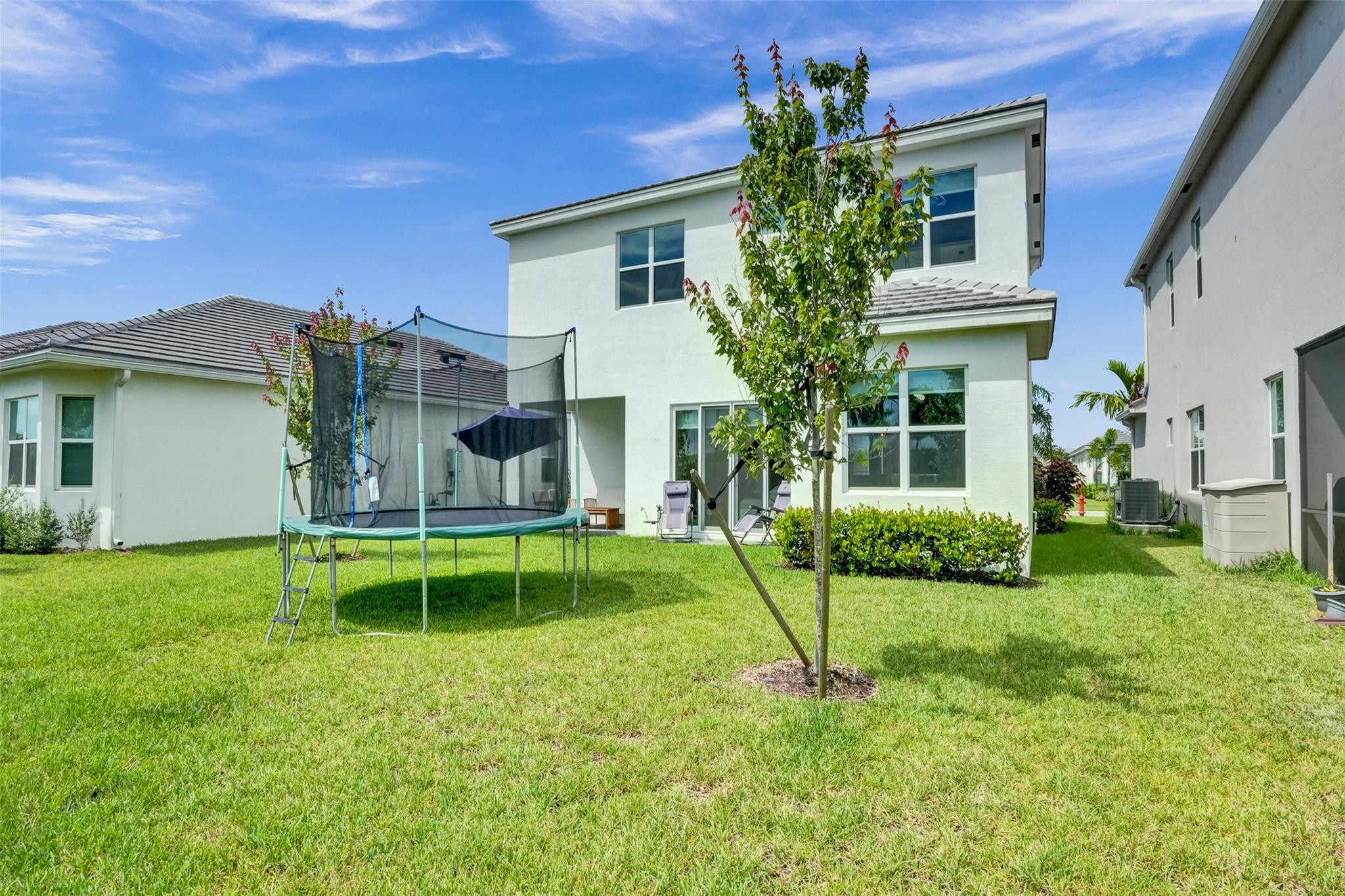 5416 Macoon Way Loxahatchee, FL 33470 - Photo 29 of 43 a view of a house with a yard and sitting area