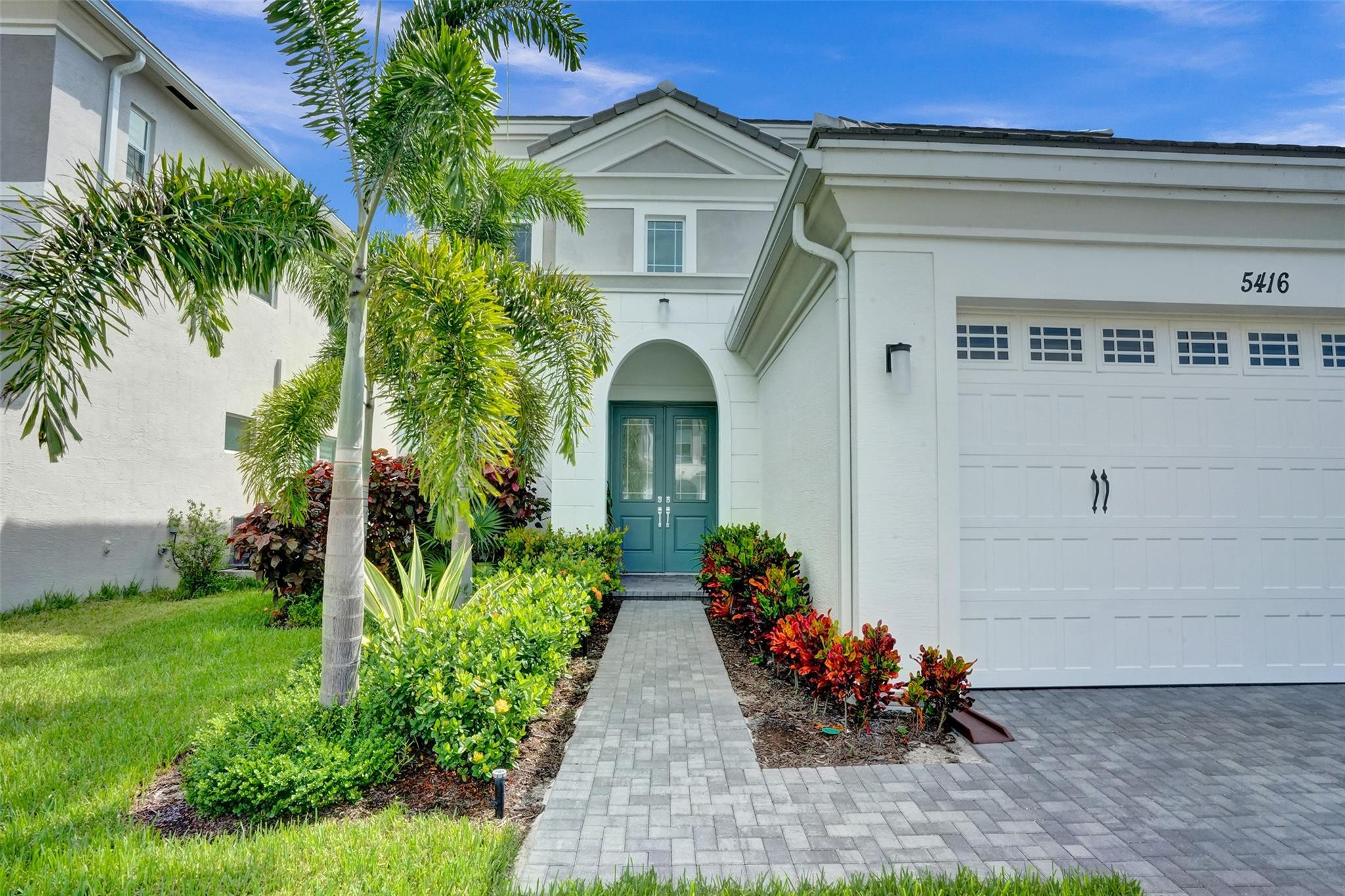 5416 Macoon Way Loxahatchee, FL 33470 - Photo 3 of 43 a front view of a house with a yard