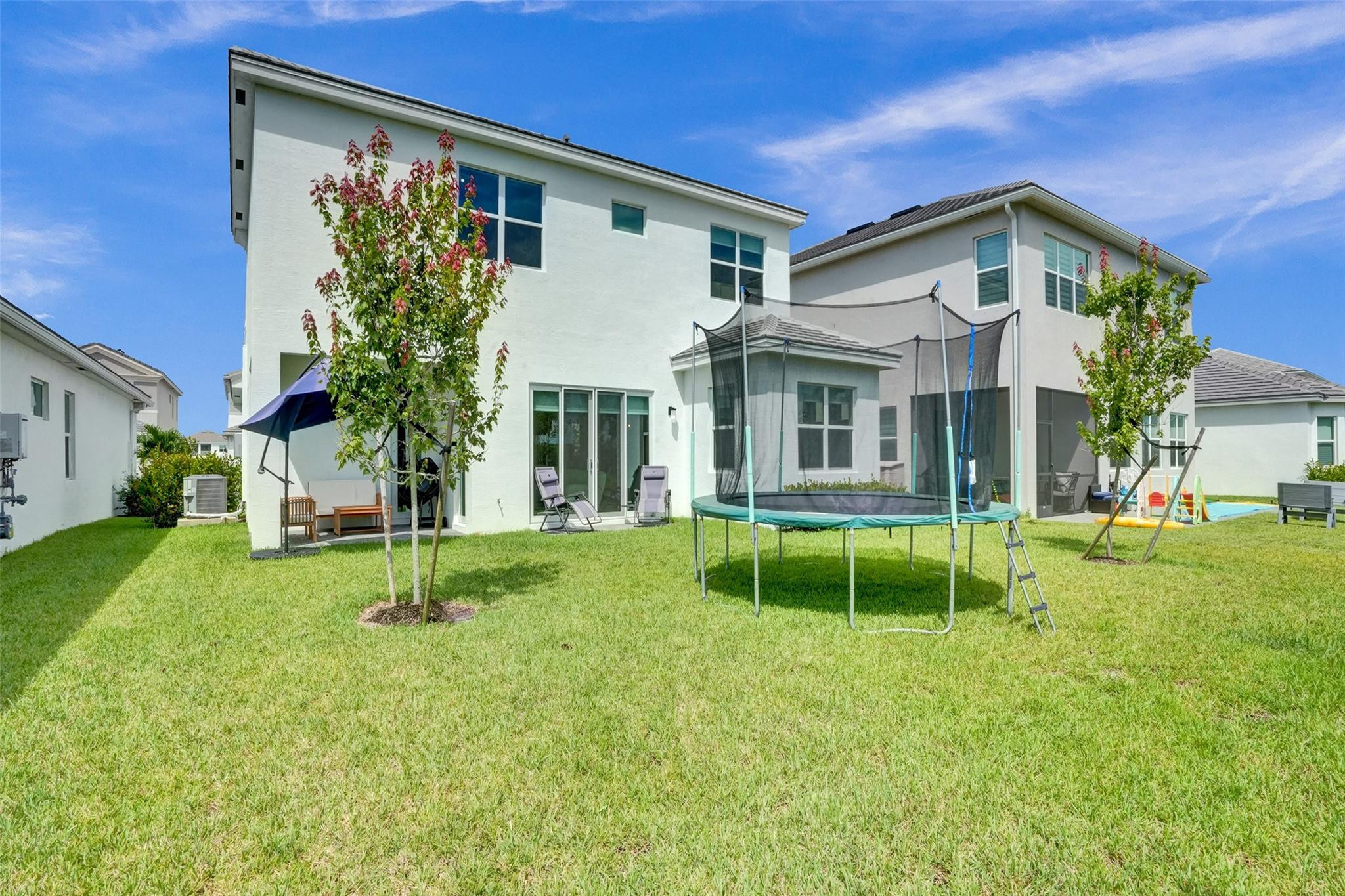 5416 Macoon Way Loxahatchee, FL 33470 - Photo 34 of 43 a front view of house with a garden