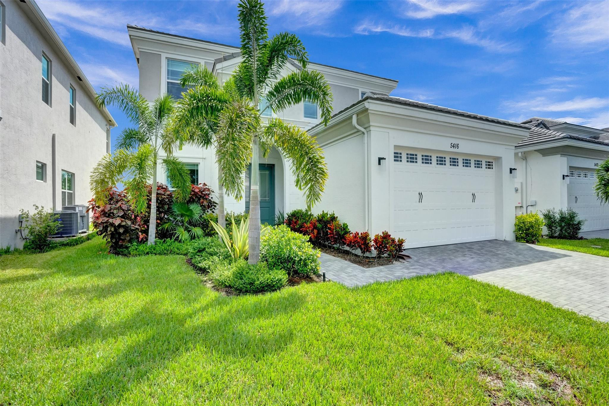 5416 Macoon Way Loxahatchee, FL 33470 - Photo 35 of 43 a view of a house with porch and garden