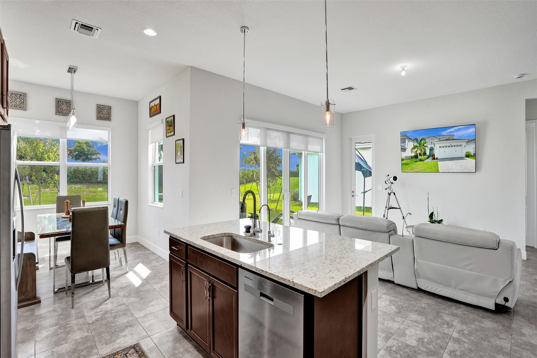 5416 Macoon Way Loxahatchee, FL 33470 - Photo 7 of 43 a kitchen with stainless steel appliances granite countertop a sink a counter space and living room view