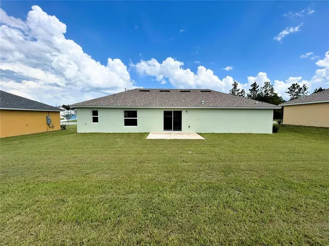 a front view of house with yard and garage
