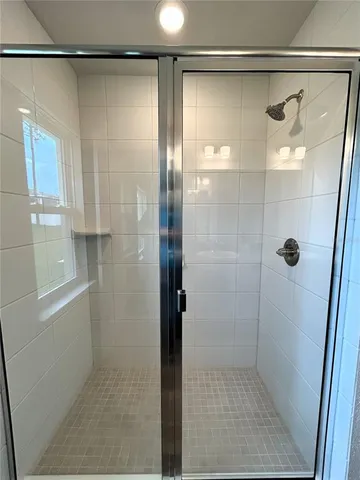 a bathroom with a glass door shower