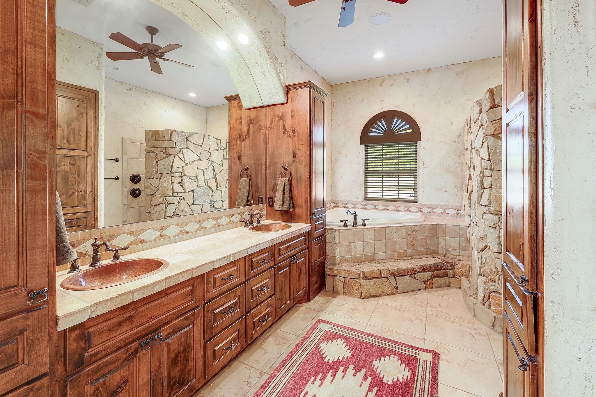 1120 Redbird Road Granger, TX 76530 - Photo 19 of 40 Full bath featuring ceiling fan, a garden tub, double vanity, and walk in shower