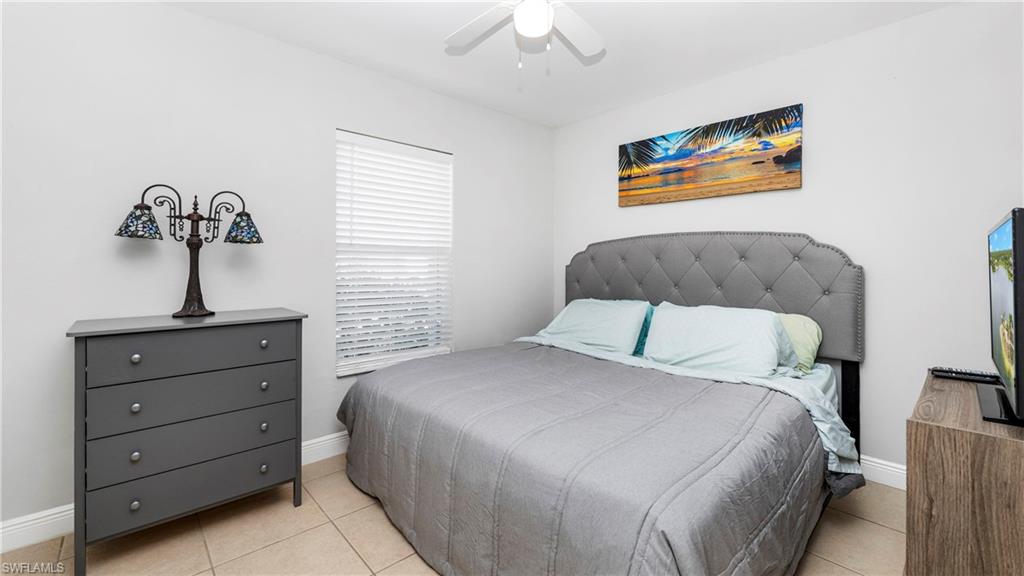 3340 2nd Avenue Southeast Naples, FL 34117 - Photo 15 of 24 a bedroom with a bed and a painting on the wall