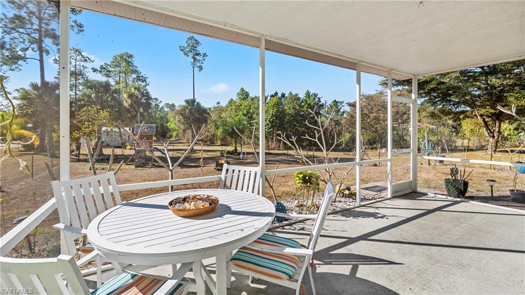 3340 2nd Avenue Southeast Naples, FL 34117 - Photo 20 of 24 a view of a swimming pool with outdoor seating and plants