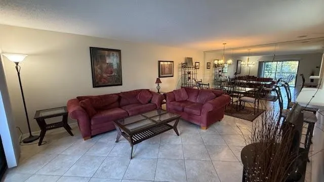 a living room with furniture and a view of kitchen