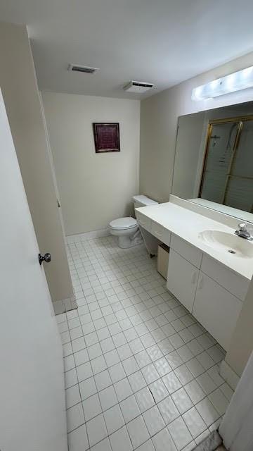 2334 South Cypress Bend Drive, Unit 204 Pompano Beach, FL 33069 - Photo 15 of 25 a bathroom with a sink a toilet and a mirror