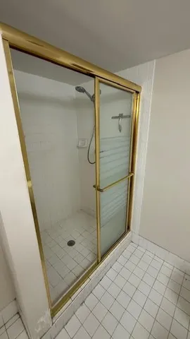 a bathroom with a glass shower door