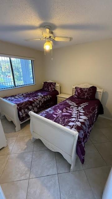 2334 South Cypress Bend Drive, Unit 204 Pompano Beach, FL 33069 - Photo 17 of 25 a bed sitting in a bedroom next to a window