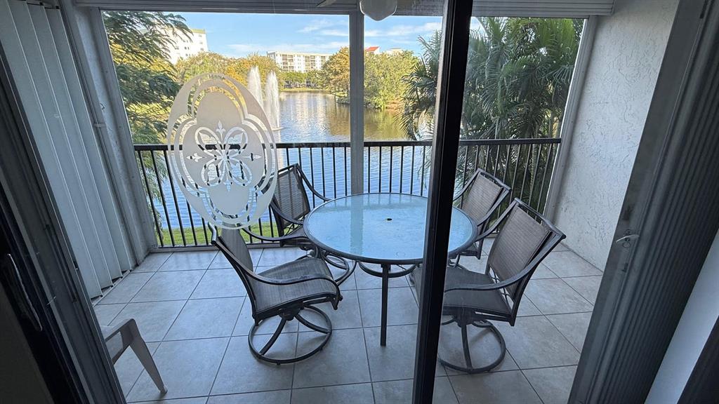 2334 South Cypress Bend Drive, Unit 204 Pompano Beach, FL 33069 - Photo 18 of 25 a view of a room with furniture wooden floor and windows