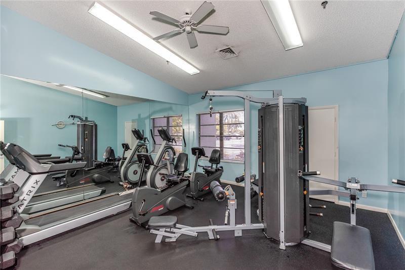 2334 South Cypress Bend Drive, Unit 204 Pompano Beach, FL 33069 - Photo 23 of 25 a view of a room with gym equipment