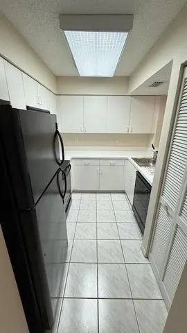 a kitchen with a sink and a refrigerator