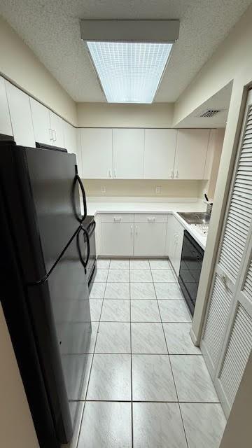 2334 South Cypress Bend Drive, Unit 204 Pompano Beach, FL 33069 - Photo 7 of 25 a kitchen with a sink and a refrigerator