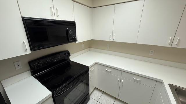 2334 South Cypress Bend Drive, Unit 204 Pompano Beach, FL 33069 - Photo 8 of 25 a kitchen with a stove and a microwave