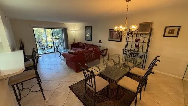 a living room with furniture a lamp and a chandelier