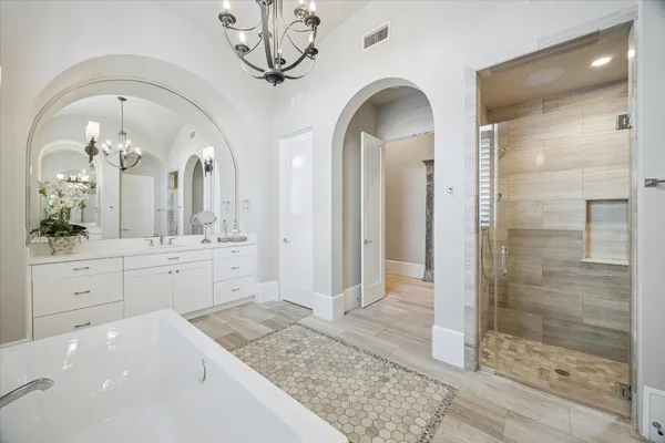 a spacious bathroom with a granite countertop sink mirror and shower