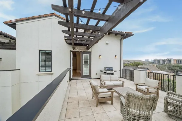 a living room with patio furniture and a fireplace