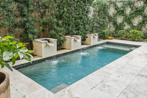 a view of a backyard with swimming pool