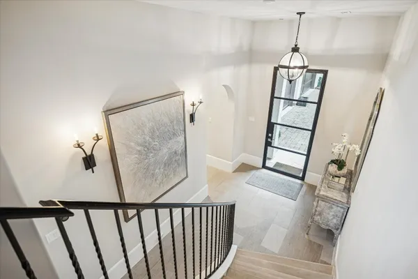 a view of hallway with wooden floor and stairs