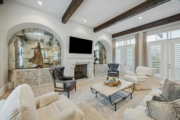 a living room with furniture fireplace and a large window