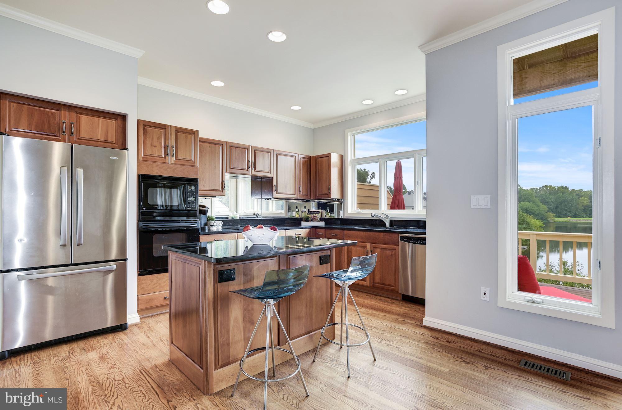 11504 Hemingway Drive Reston, VA 20194 - Photo 7 of 30 a kitchen with stainless steel appliances granite countertop a refrigerator and a stove top oven