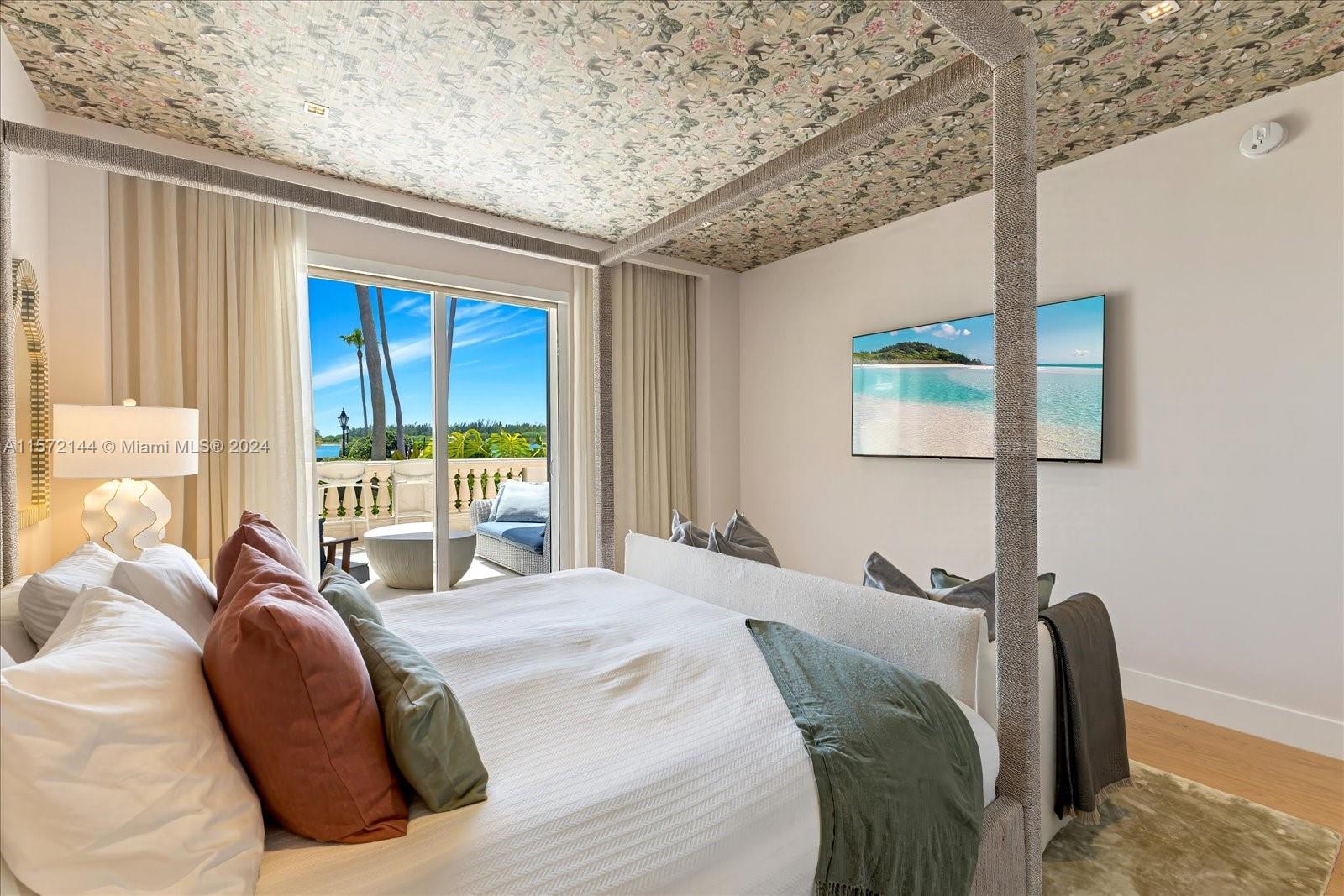 2113 Fisher Island Drive, Unit 2113 Miami Beach, FL 33109 - Photo 16 of 49 a bed sitting in a bedroom next to a window