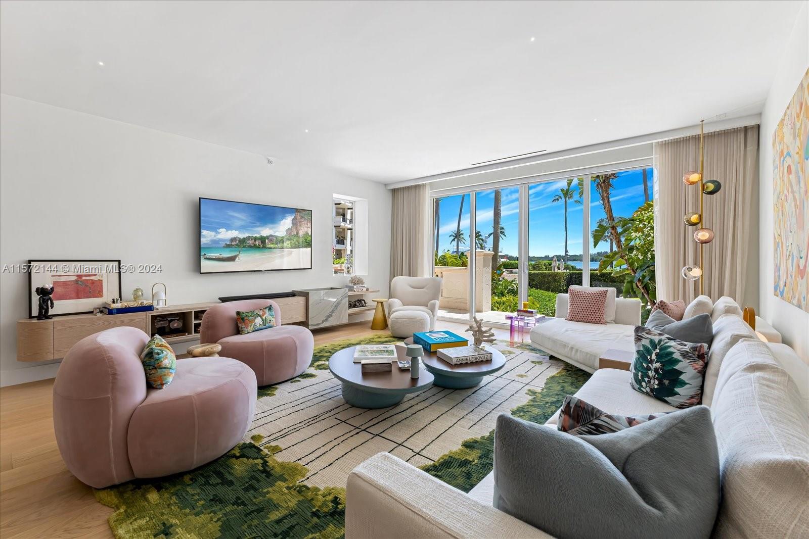 2113 Fisher Island Drive, Unit 2113 Miami Beach, FL 33109 - Photo 2 of 49 a living room with furniture fireplace and a large window
