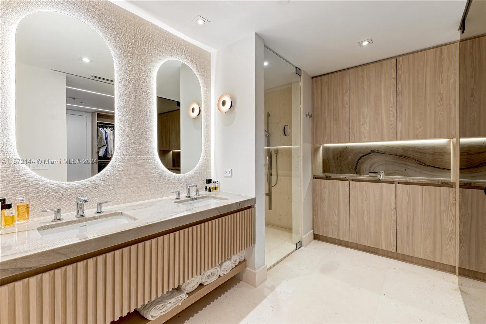 2113 Fisher Island Drive, Unit 2113 Miami Beach, FL 33109 - Photo 21 of 49 a bathroom with a double vanity sink and mirror