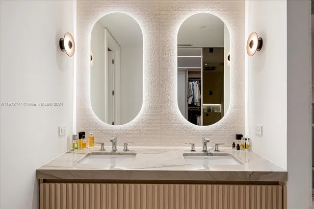 a bathroom with a double vanity sink a mirror and a bathtub