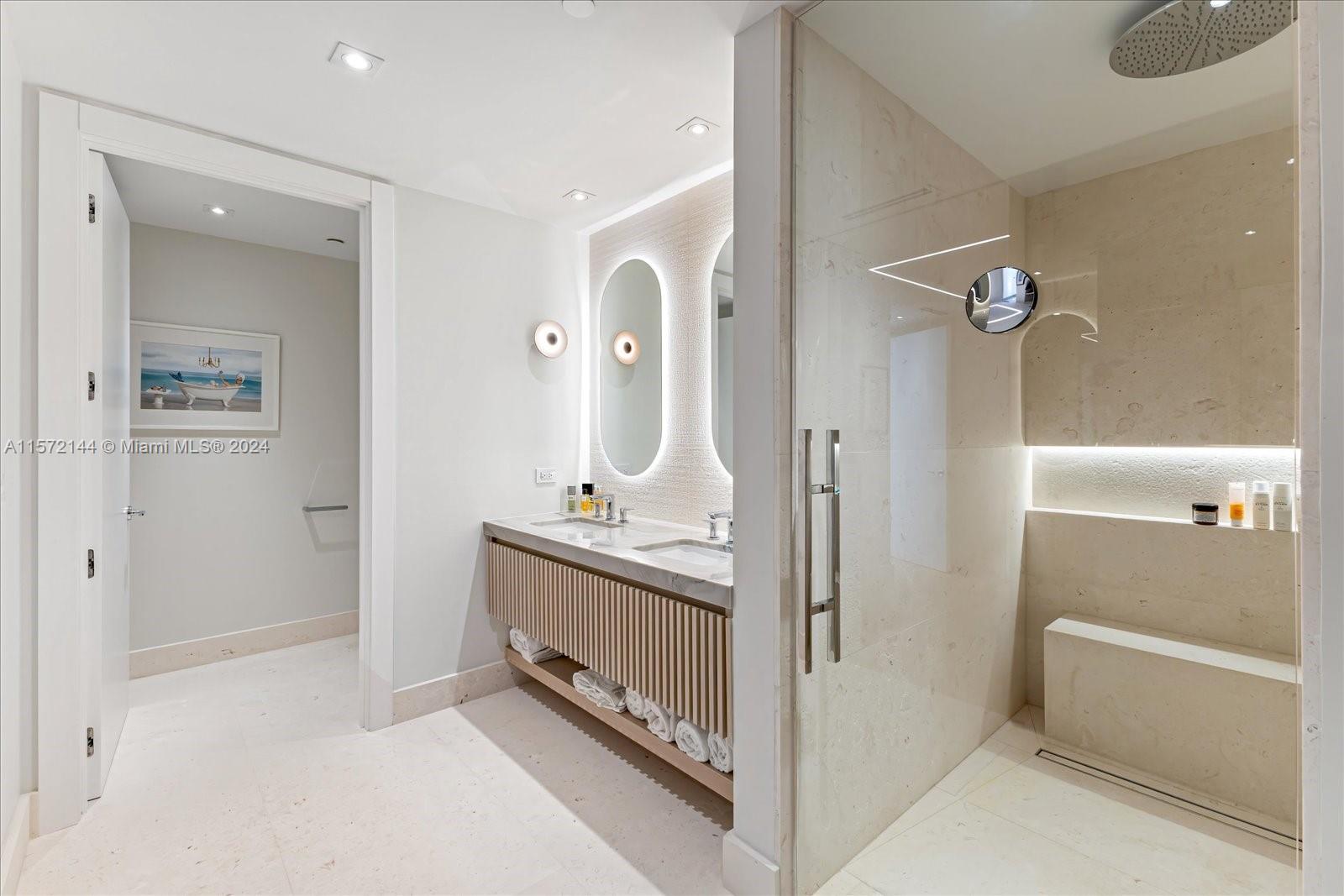 2113 Fisher Island Drive, Unit 2113 Miami Beach, FL 33109 - Photo 23 of 49 a bathroom with a double vanity sink a mirror and a bathtub