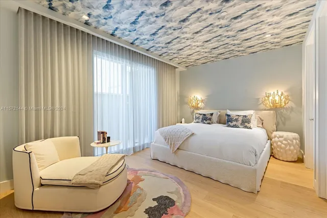 a bedroom with a bed and a painting on the wall