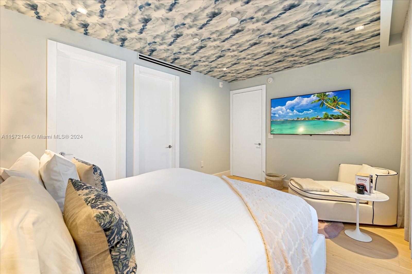 2113 Fisher Island Drive, Unit 2113 Miami Beach, FL 33109 - Photo 25 of 49 a bedroom with a bed and a painting on the wall