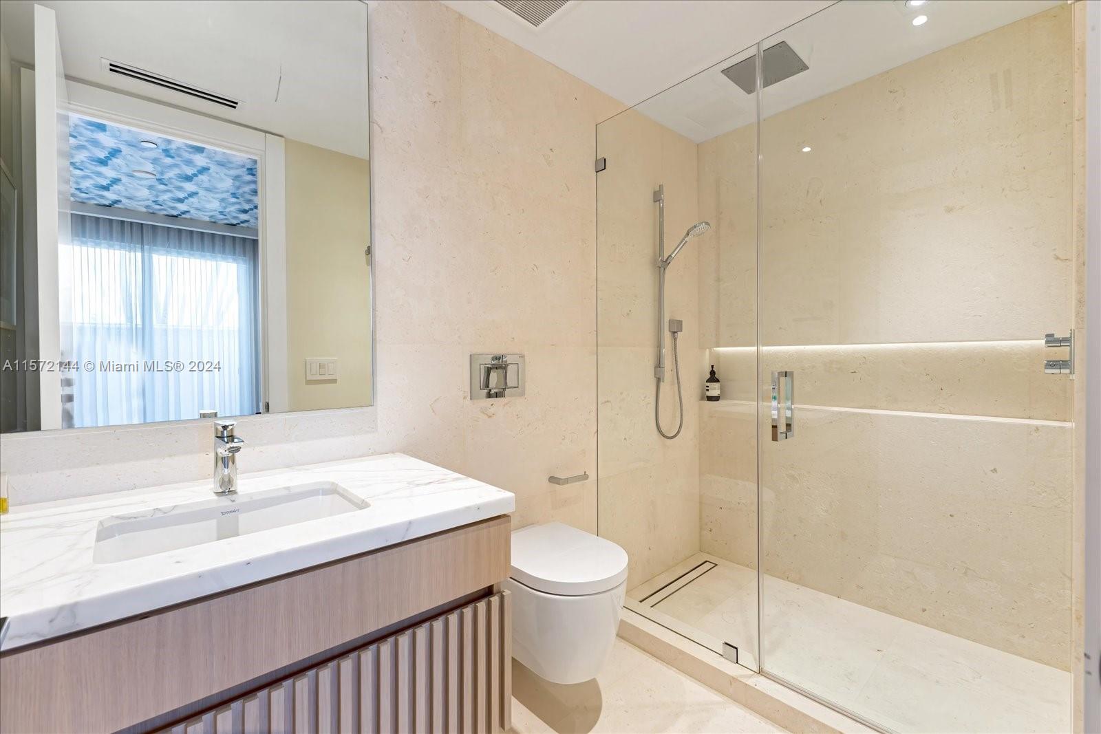 2113 Fisher Island Drive, Unit 2113 Miami Beach, FL 33109 - Photo 26 of 49 a bathroom with a sink a toilet and shower