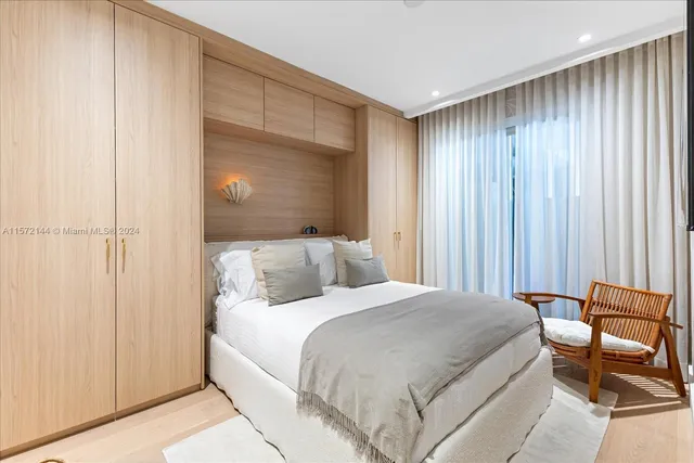 a bedroom with a bed and a chair