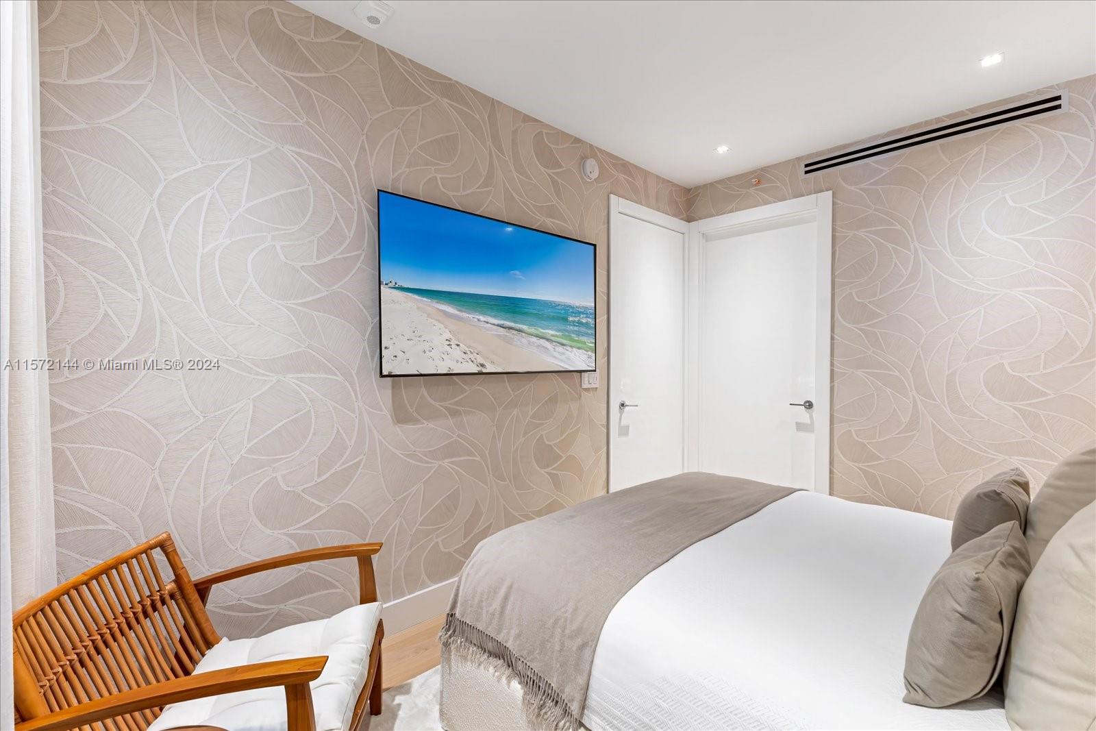 2113 Fisher Island Drive, Unit 2113 Miami Beach, FL 33109 - Photo 28 of 49 a bedroom with a bed and a chair