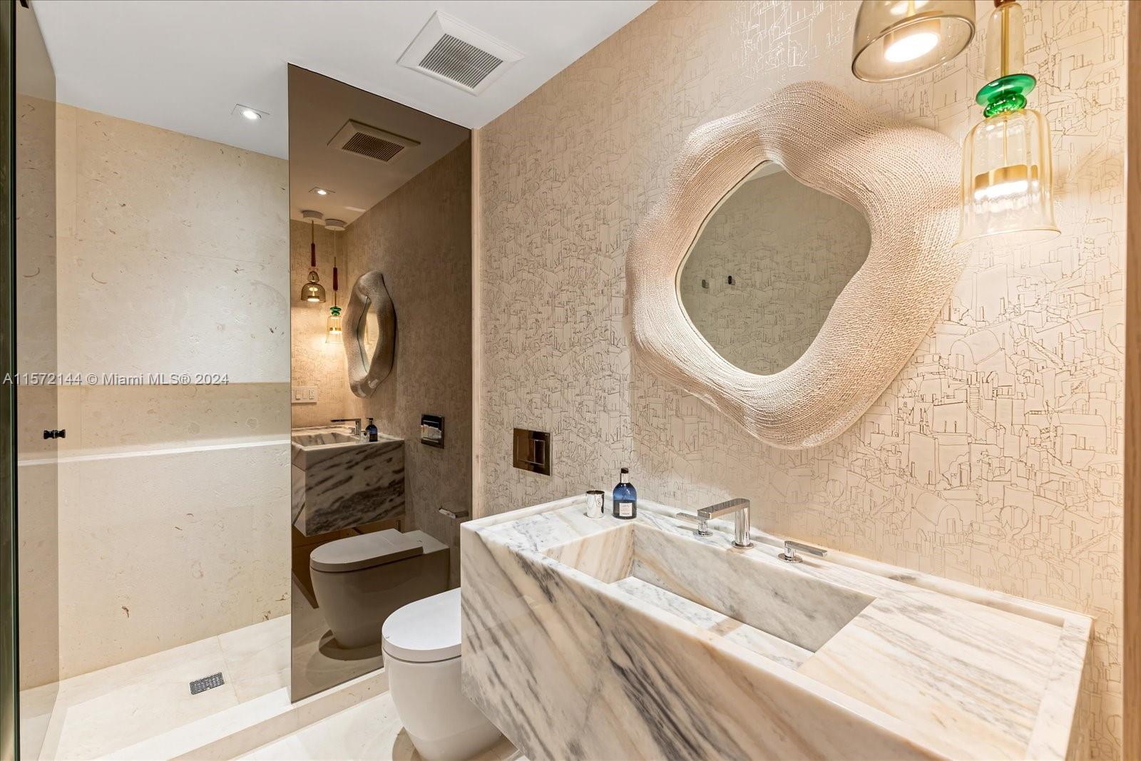 2113 Fisher Island Drive, Unit 2113 Miami Beach, FL 33109 - Photo 30 of 49 a spacious bathroom with a sink a toilet and shower