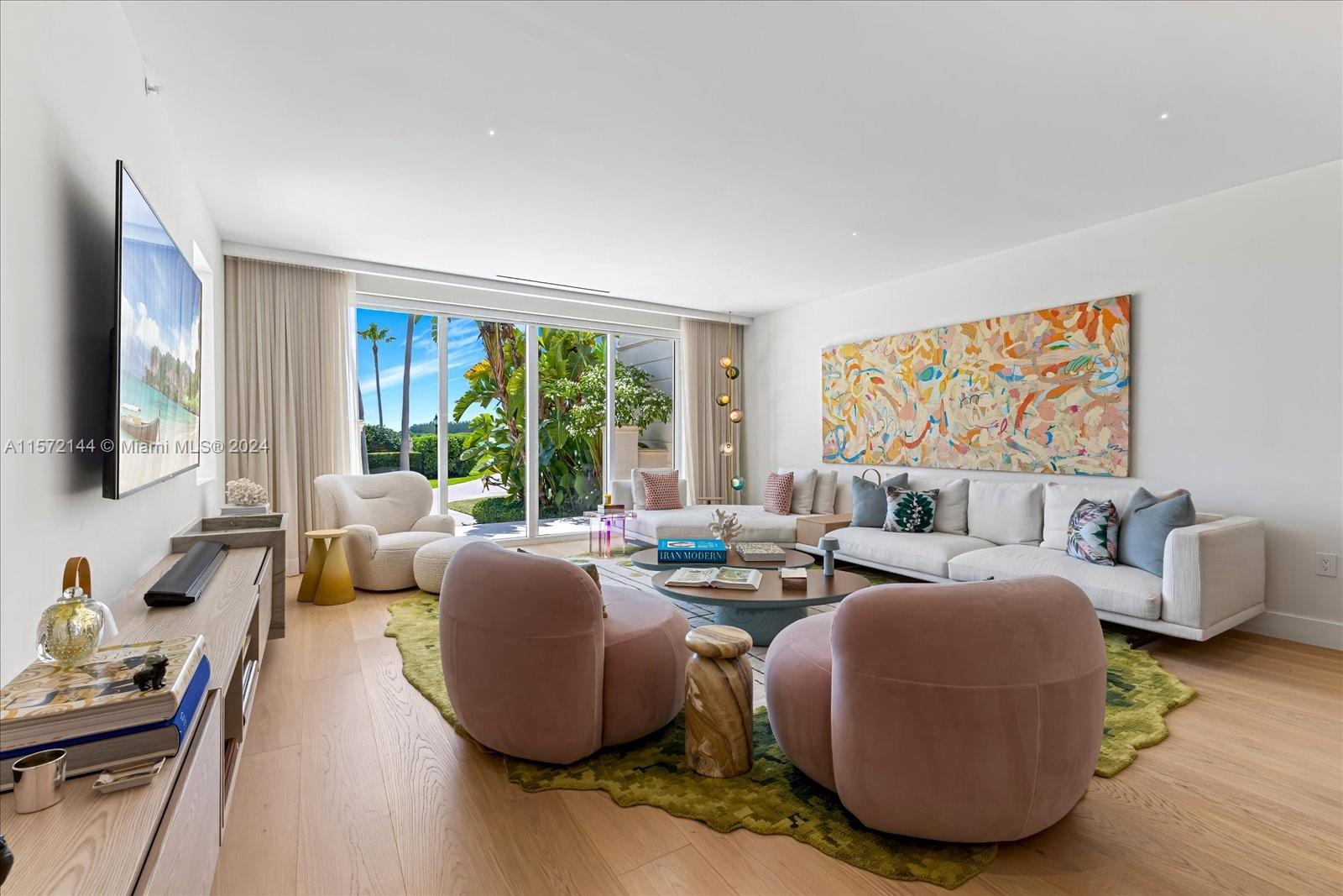 2113 Fisher Island Drive, Unit 2113 Miami Beach, FL 33109 - Photo 3 of 49 a living room with furniture large window and flat screen tv