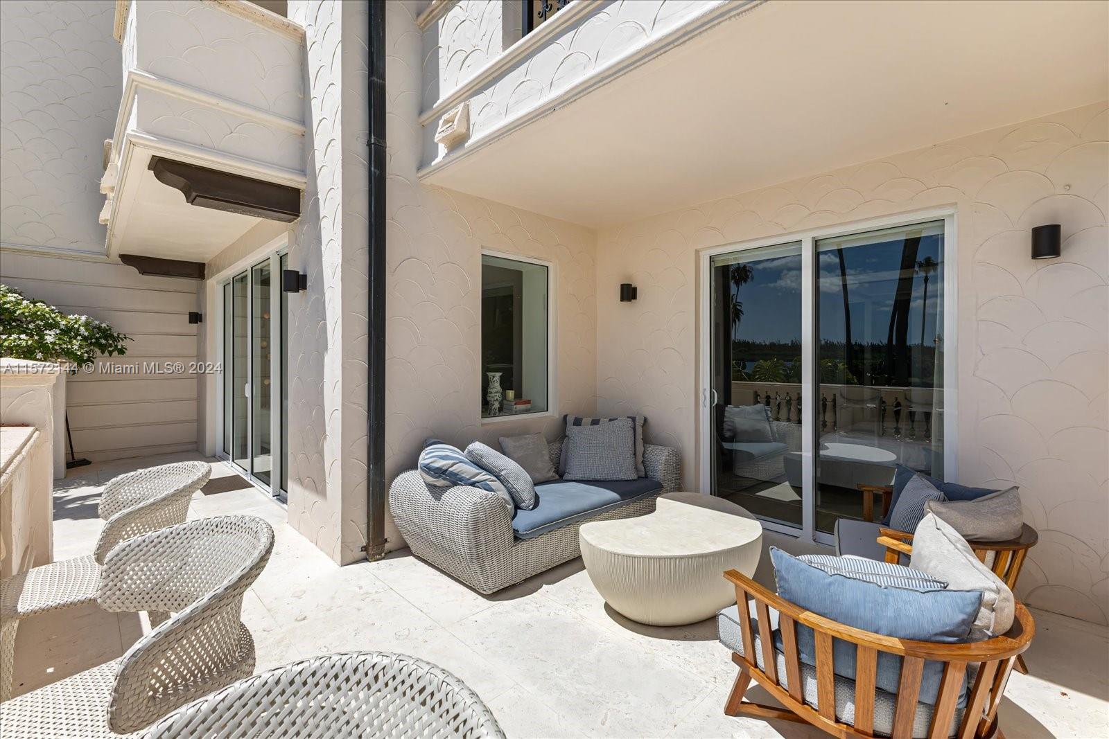 2113 Fisher Island Drive, Unit 2113 Miami Beach, FL 33109 - Photo 32 of 49 a living room with furniture and a large window