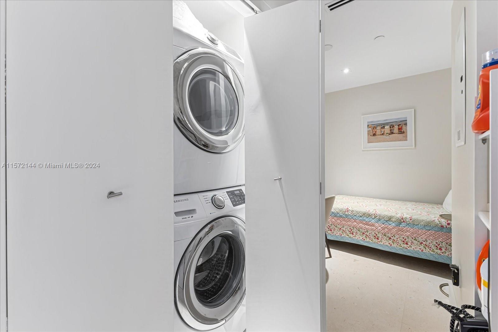 2113 Fisher Island Drive, Unit 2113 Miami Beach, FL 33109 - Photo 33 of 49 a bedroom with a washer and dryer