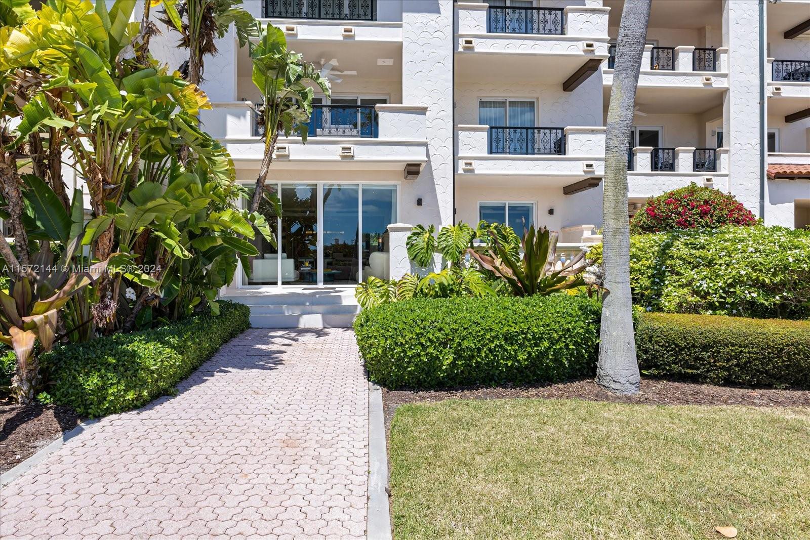 2113 Fisher Island Drive, Unit 2113 Miami Beach, FL 33109 - Photo 35 of 49 a front view of a building with a garden