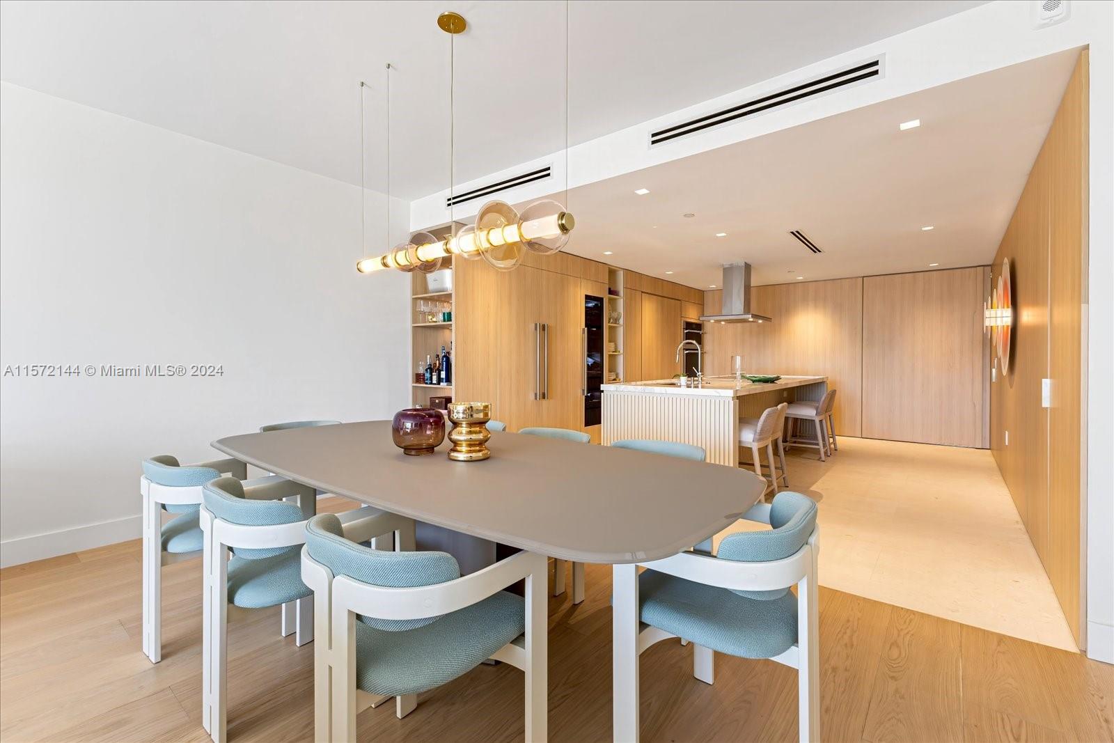 2113 Fisher Island Drive, Unit 2113 Miami Beach, FL 33109 - Photo 8 of 49 a view of a dining room with furniture and wooden floor