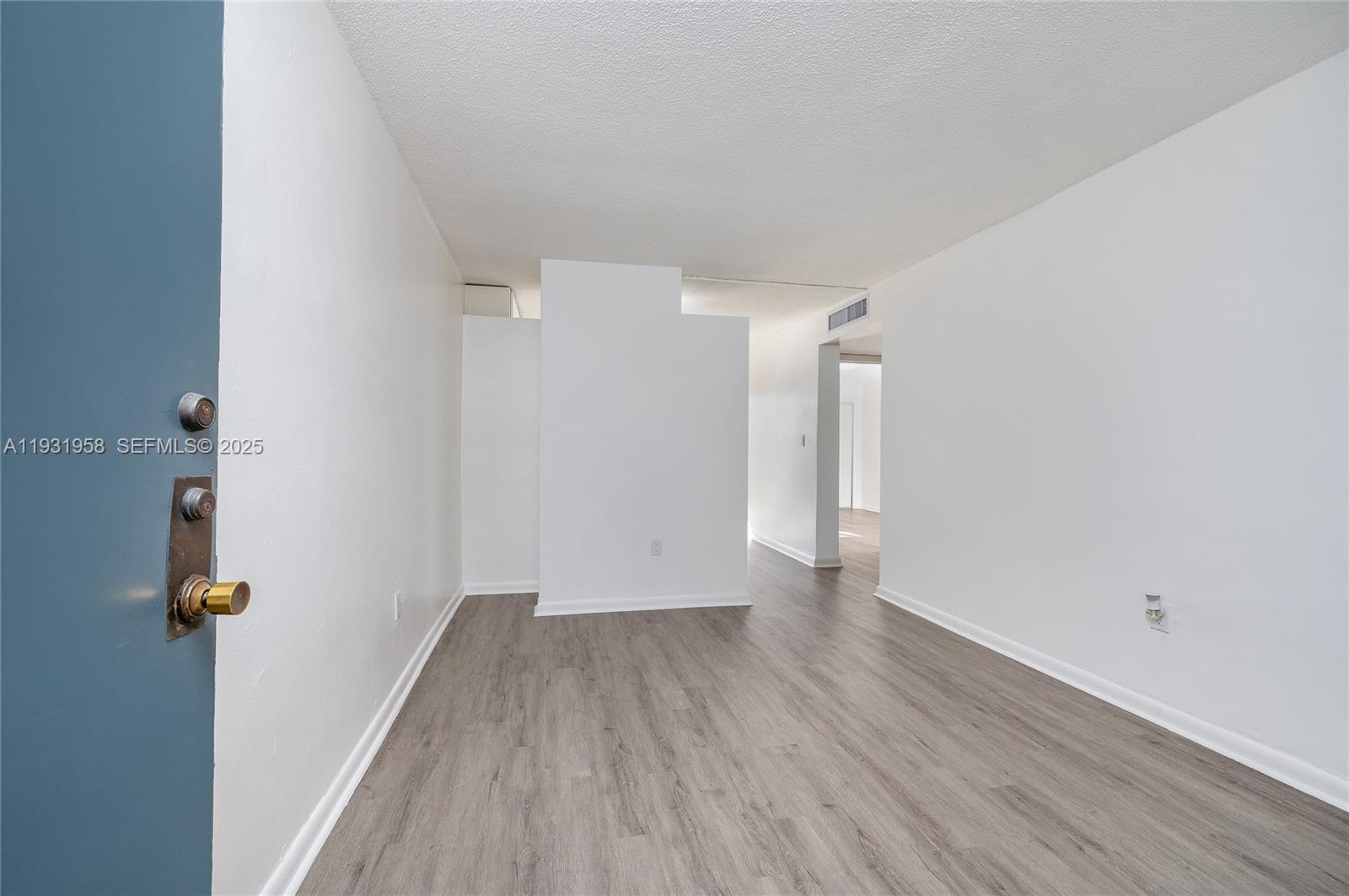 444 Southwest 27th Avenue, Unit 37 Miami, FL 33135 - Photo 10 of 18 a view of a room with wooden floor and white walls