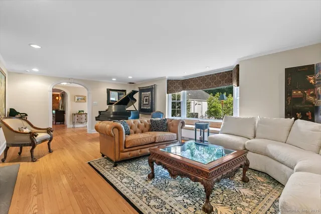 a living room with furniture a rug and a large window