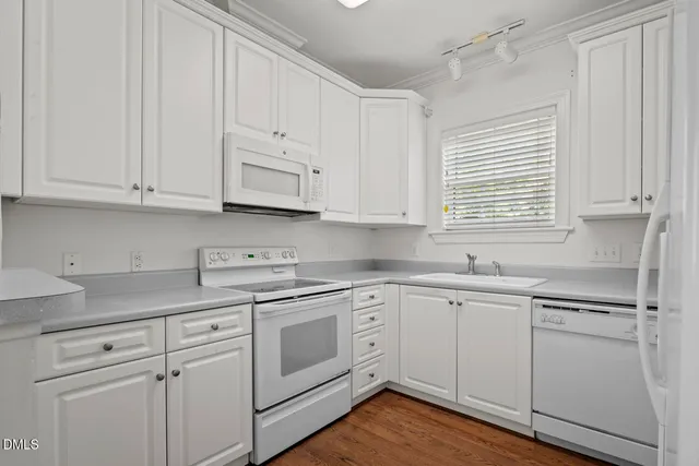 a kitchen with stainless steel appliances white cabinets and a sink