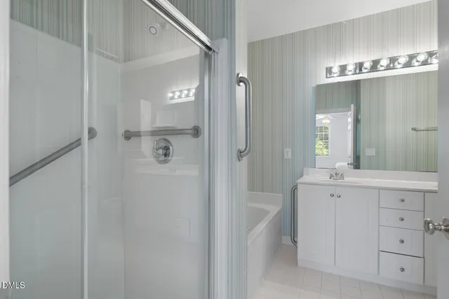 an empty room with closet and a chandelier fan