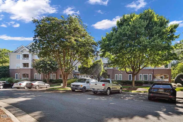a view of a hallway with closet and wooden floor